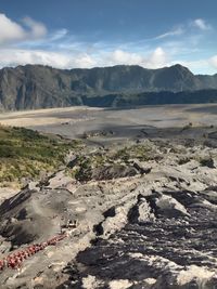 Scenic view of land and mountains against sky