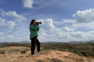 Rear view of woman standing on mountain