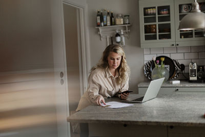 Woman using laptop at home