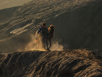 Rear view of man standing on rock