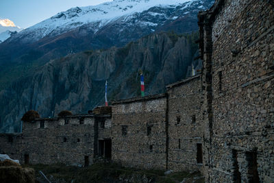 View of buildings against snowcapped mountain