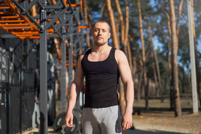 Portrait of young man standing outdoors
