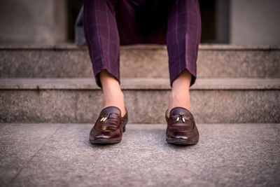 Low section of man sitting on steps