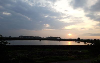Scenic view of lake against sky during sunset