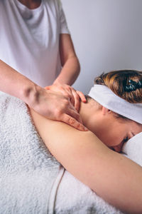 Midsection of woman lying on hand