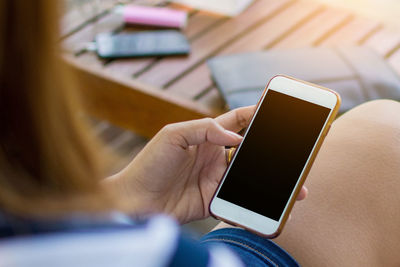 Midsection of woman using mobile phone