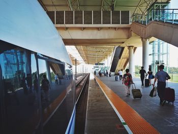 People standing on railroad station platform