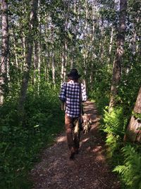 Full length of woman standing in forest