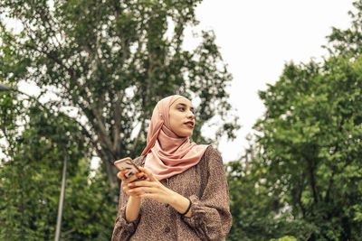 Muslim woman using a phone