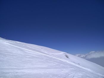 Scenic view of snowcapped mountain against blue sky