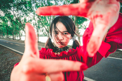 Portrait of woman holding red umbrella