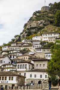 Low angle view of buildings in town against sky