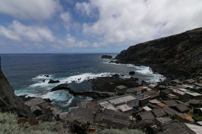 Scenic view of sea and buildings against sky