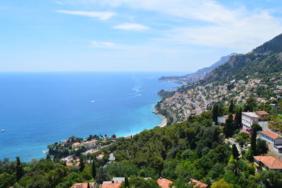 High angle view of townscape by sea against sky