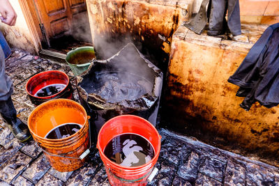 High angle view of dye in containers on footpath