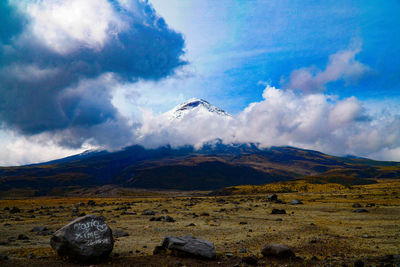 Scenic view of land and mountains against sky