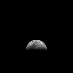 Low angle view of moon against sky at night