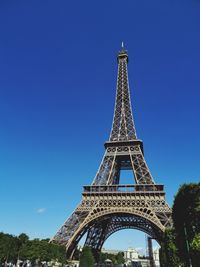 Low angle view of eiffel tower against blue sky