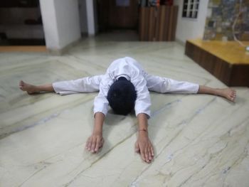 High angle view of man lying on floor at home