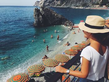 Woman looking at sea while standing on balcony