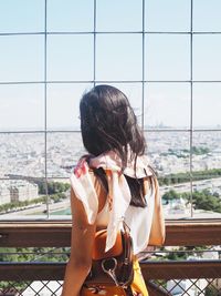 Woman sitting on window looking at view