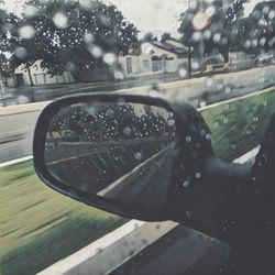 Close-up of car on road