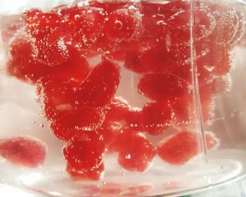 Close-up of red berries in glass