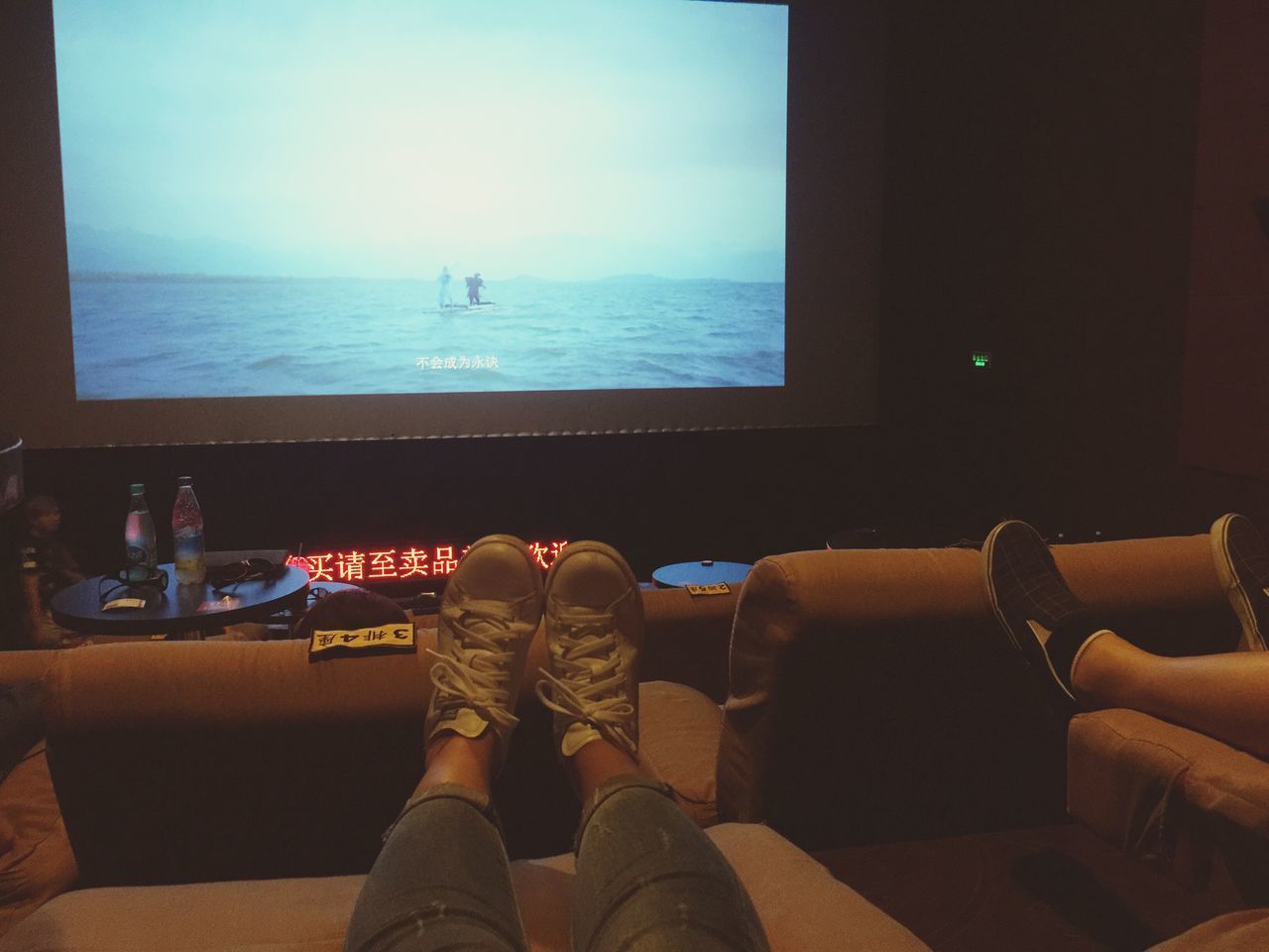 low section, person, sea, relaxation, personal perspective, water, barefoot, horizon over water, sitting, window, human foot, vacations, togetherness, sky, resting, day