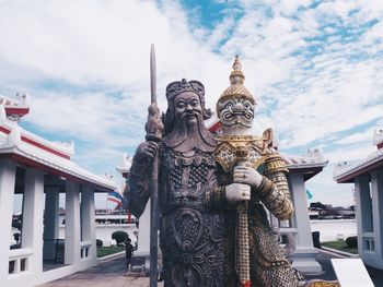 Statue of temple against building