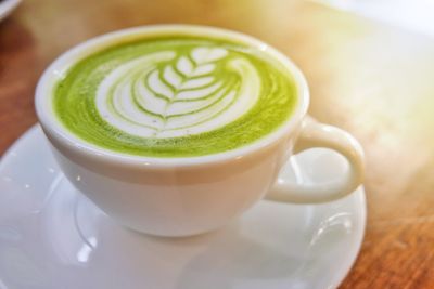 Close-up of green tea latte art in cafe