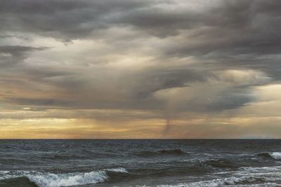 Scenic view of sea against dramatic sky