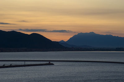 Scenic view of lake against sky during sunset