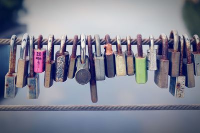 Close-up of padlocks hanging against sky