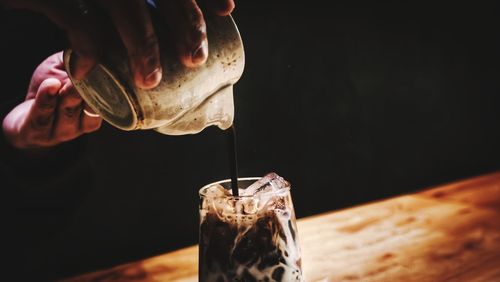 Close-up of hand pouring matcha, green tea