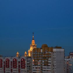 View of cityscape against clear sky at night