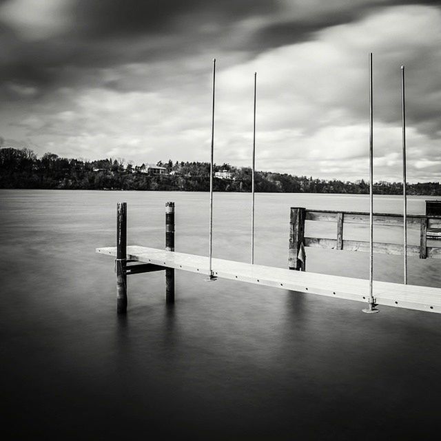 sky, cloud - sky, water, cloud, pole, cloudy, tranquility, pier, tranquil scene, nature, sea, day, built structure, bench, outdoors, absence, railing, empty, street light, wooden post