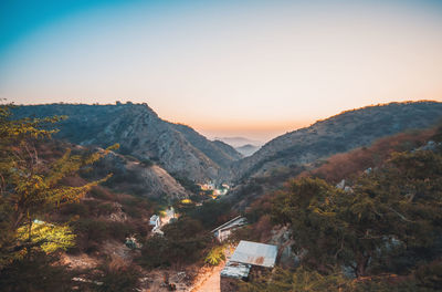 Scenic view of mountains against clear sky during sunset