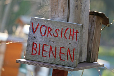 Close-up of information sign on wood