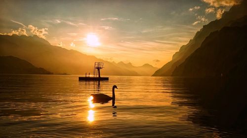 Scenic view of lake against sky during sunset