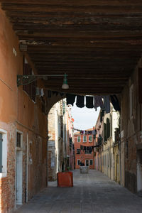 Empty alley amidst buildings in town