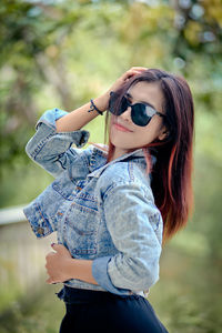 Young woman wearing sunglasses standing outdoors