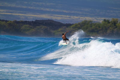 Man surfing in swimming pool against sky