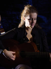 Young woman playing guitar