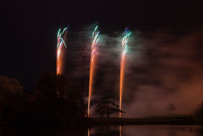 Low angle view of firework display at night
