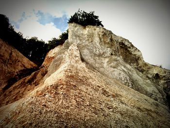 Low angle view of rock formations against sky