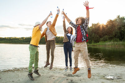Rear view of couple standing at lakeshore
