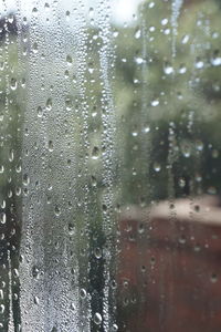 Full frame shot of wet glass window during rainy season