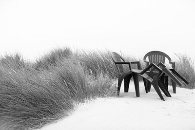 Built structure on beach against clear sky during winter