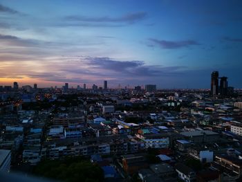 High angle view of city buildings against sky during sunset