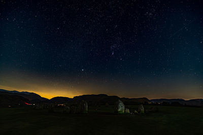 Scenic view of mountains against sky at night